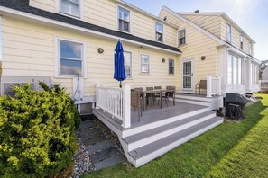 A two-story house with a covered patio, a small garden, and a grill area. - Luxury 4 Bed, 3.5 Bath Oceanfront Home, KBIA, Mother’s Beach (Kennebunk)