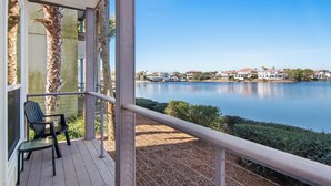 A balcony with a view of a lake and houses in the distance. - ☀️Steps to Beach🌴Pool+Lake View | Destiny Beach Villas #9B☀️ (Destin)