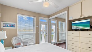 A bedroom with a bed, a television, a chair, and a wardrobe. - ☀️Steps to Beach🌴Pool+Lake View | Destiny Beach Villas #9B☀️ (Destin)