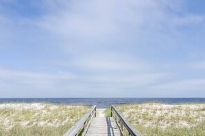 A wooden boardwalk leading to the beach. - 2-Bed 2-Bath Oceanfront Condo in Carolina Beach with 2 Pools and Beach Access! (Carolina Beach)
