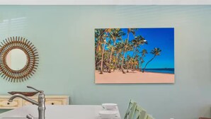 A dining area with a white table, four white bowls, and a modern faucet. - Cozy villa in Margaritaville Orlando, near Disney, SeaWorld, Universal (Kissimmee)