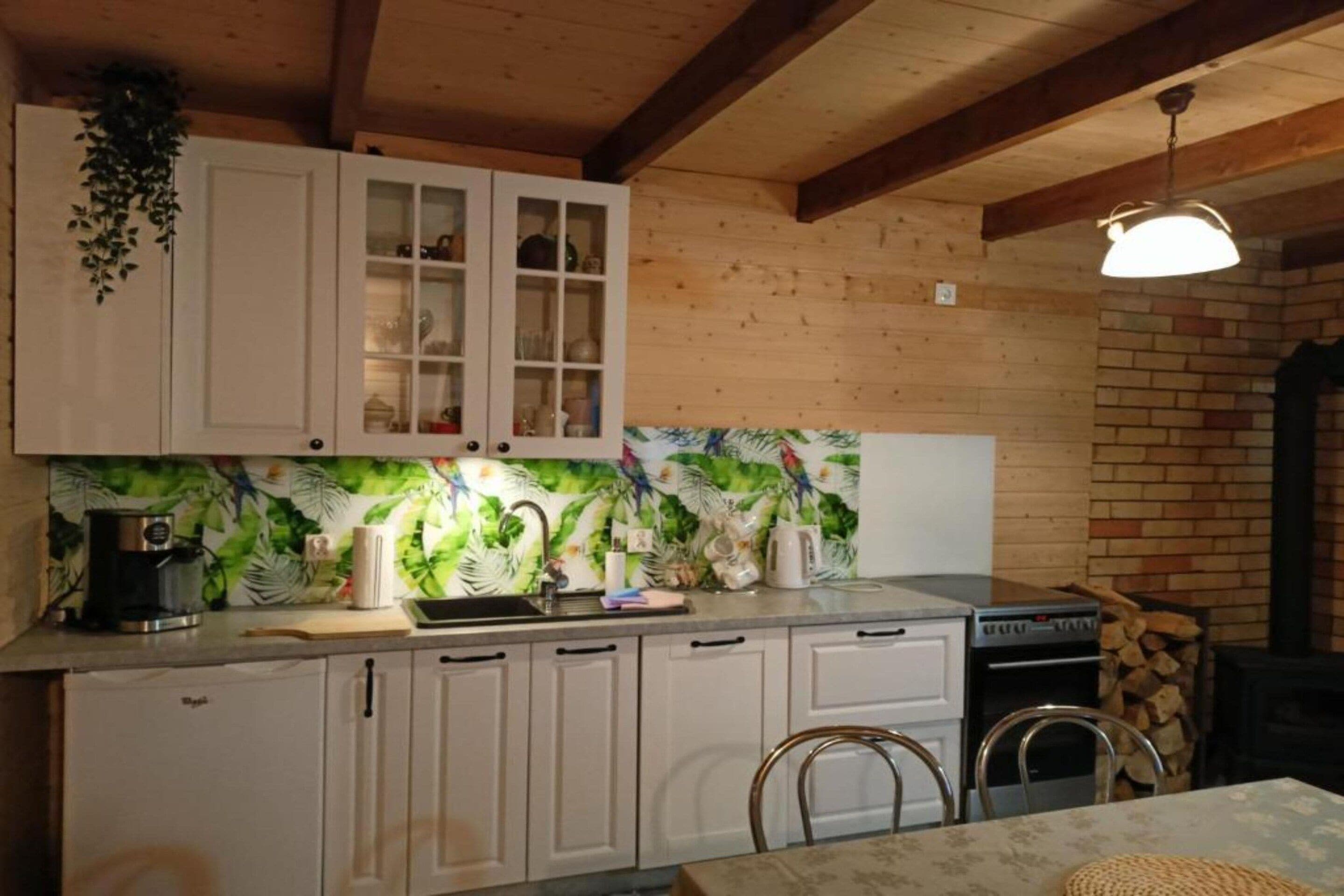 A kitchen with white cabinets, a coffee maker, and a stove.