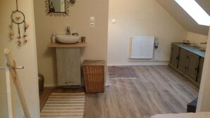 A bedroom with a sloped ceiling, a bed, a dresser, and a window. - Whole house in town, pets welcome (Caudry)