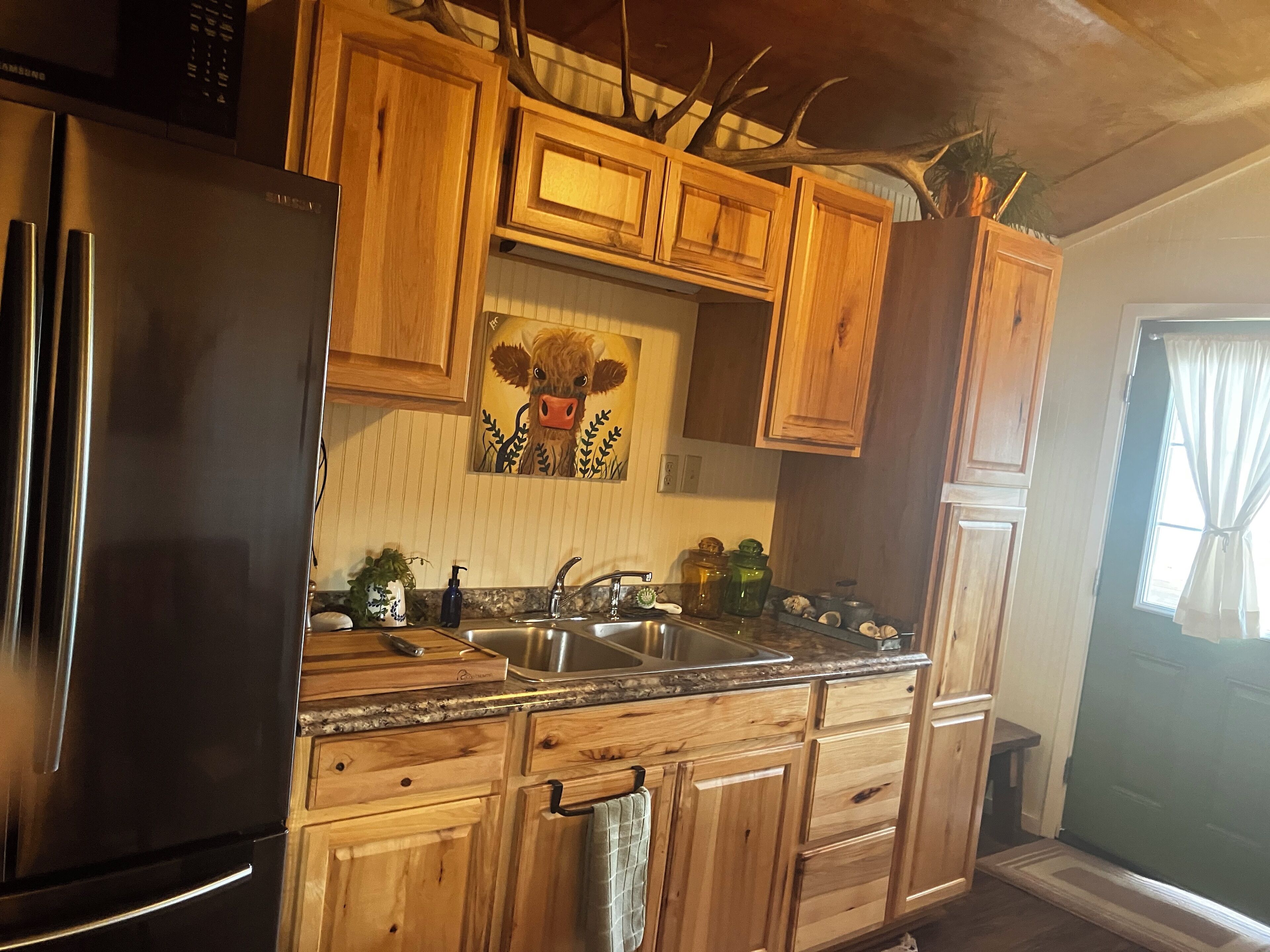 Fridge, microwave, coffee/tea maker, cookware/dishes/utensils