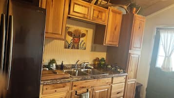 Fridge, microwave, coffee/tea maker, cookware/dishes/utensils