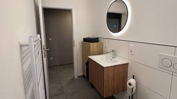 Regadera, secadora de cabello, toallas, papel de baño