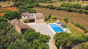 A villa with a swimming pool surrounded by lush greenery and fields. - Xim vell by Interhome (Felanitx)