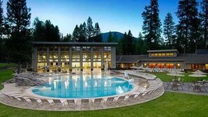 A hotel with a large pool, outdoor seating, and a building with multiple windows. - Black Butte Ranch Lodge Room 030 (Black Butte Ranch)