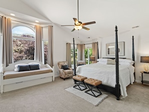 A bedroom with a four-poster bed, a window seat, a ceiling fan, and a view of trees. - Grand Mountain Retreat: Hot Tub, Sauna, Sleeps 21, Sofa Sleeper on Main Floor (Draper)