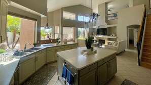 A spacious kitchen with a large island, built-in appliances, and ample natural light from large windows. - Wonderful 5-bedroom house in welcoming Gilbert (Gilbert)
