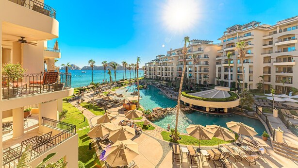 A resort with multiple balconies, a central pool, and a view of the sea. - Premium Ocean Views & Unbeatable Convenience: Villa La Estancia 1303 (Cabo San Lucas)