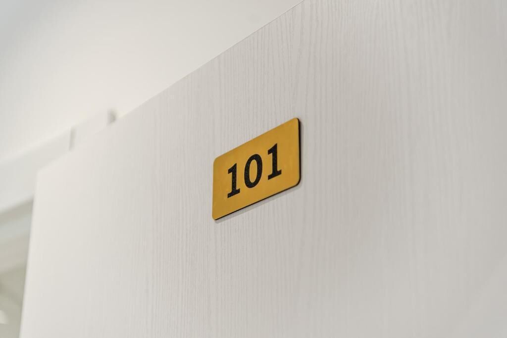 A wall with a number sign indicating room 101.