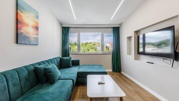 Family Apartment, Hill View | Living area | Flat-screen TV