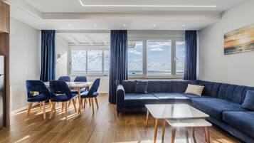 Deluxe Apartment, Sea View | Living area | Flat-screen TV