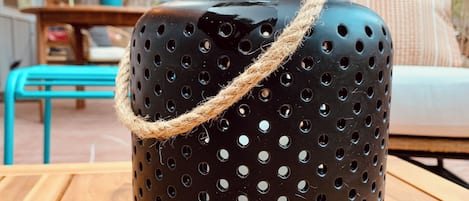 A black pot with a rope handle on a wooden table.