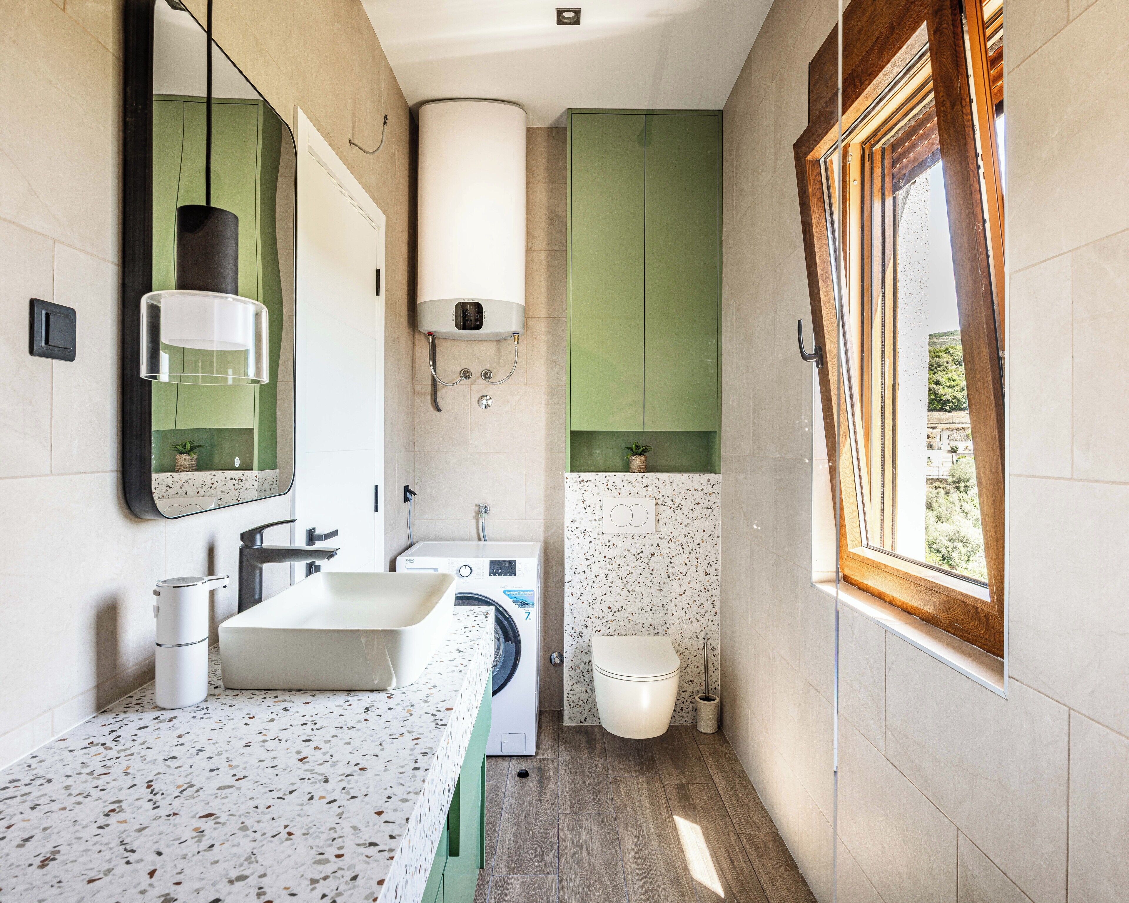 A compact bathroom with a sink, mirror, towel rack, shower, and toilet.