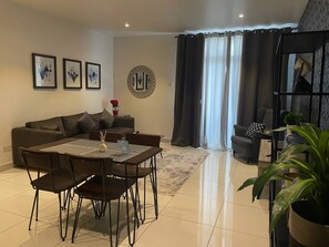 Deluxe Apartment, City View | Living area | Flat-screen TV - Embassy Onebedroom by Unique Abodes (Accra)