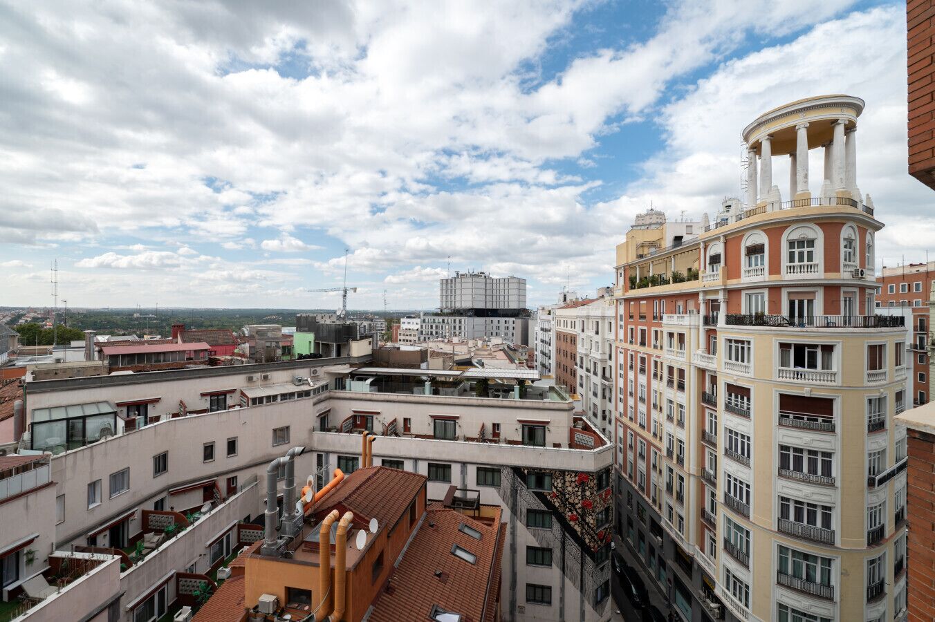 A multi-story building with balconies and a central courtyard.