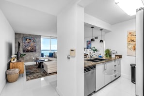 Eine moderne Wohnung mit Wohnzimmer, Küche und Balkon.