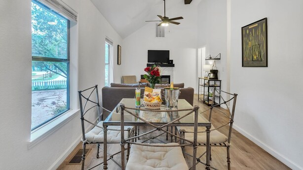 A modern interior with a dining area, a living room, and a kitchen. - Discover Affordable Luxury in the Heart of Texas Hill Country (Wimberley)