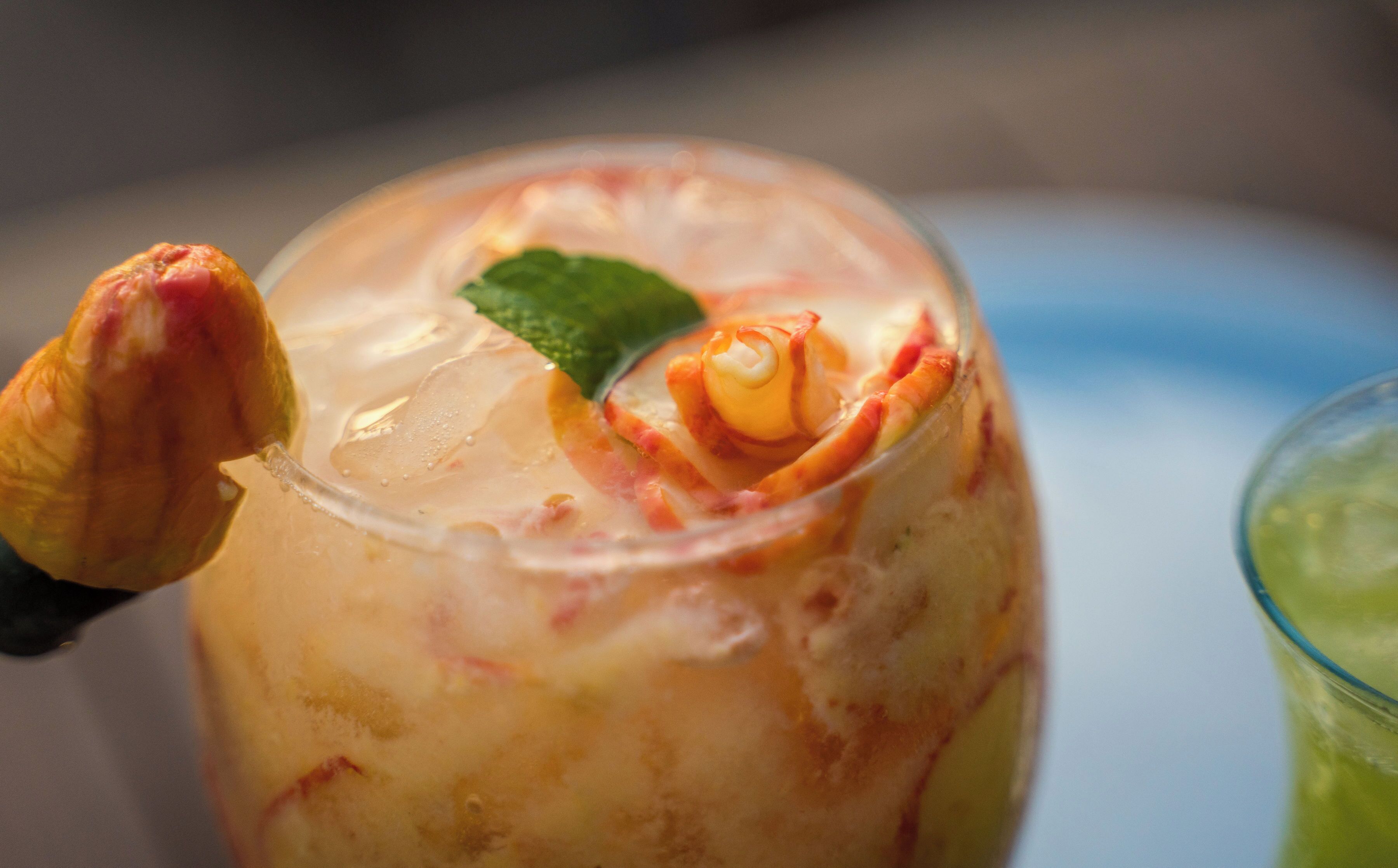 A close-up of a beverage with a garnish, possibly a cocktail or a dessert, in a glass.