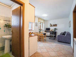 A compact living space with a kitchenette, a dining area, and a seating area. - Apartment 1510 by Interhome (Pula/Krnica)