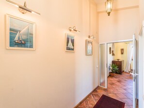 A hallway with framed maritime paintings, a tiled floor, and a door leading to another room. - Irena Apartments 2 kat / HR-10649-02 by Interhome (Selce)