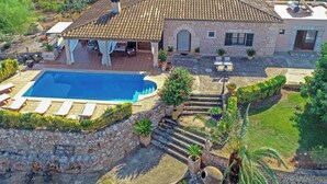 A villa with a swimming pool, outdoor seating, and a garden. - Blaypetit by Interhome (Muro)