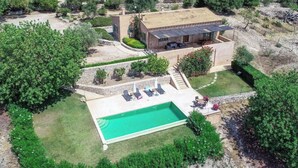 A large house with a swimming pool, surrounded by greenery and a hilly landscape. - Vacation home Calma by Interhome (Sant Llorenç des Cardassar)