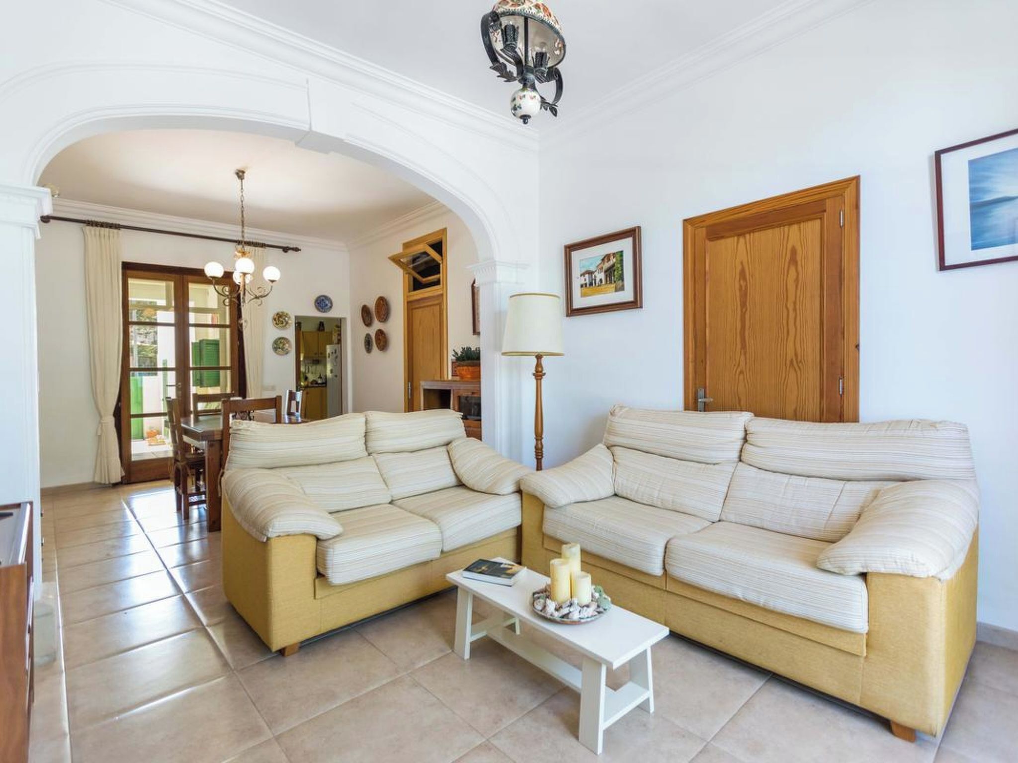 A living room with two sofas, a coffee table, a lamp, and a door.