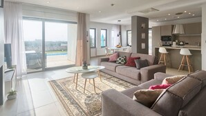A modern living room with a sofa, a coffee table, and a view of the outdoors. - Villa Volimten by Interhome (Pula/Vodnjan)