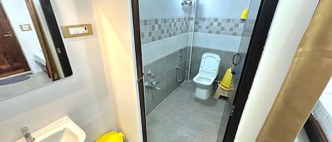 A bathroom with a sink, toilet, and shower.
