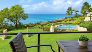 A balcony with a view of the ocean, a pool, and lush greenery. - Napili Point | Oceanfront 8 BR, Sleeps 24 | Car Incl. w/ 6+ Nights | NAP ML-3619 by KBM (Lahaina)