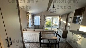Une cuisine compacte avec un coin repas, un radiateur et une vue sur l’extérieur.