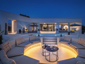 A modern outdoor living area with a pool, seating, and a well-lit entrance. - Villa Casa Q by Interhome (Sveti Petar u Šumi)