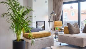 A modern living room with a sofa, armchair, and a potted plant. - Villa Grande by Interhome (Poreč/Tar)