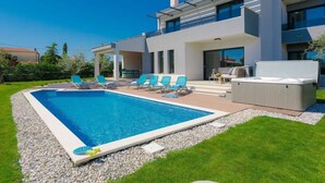 A modern two-story house with a swimming pool, outdoor seating, and a covered patio. - Villa Grande by Interhome (Poreč/Tar)