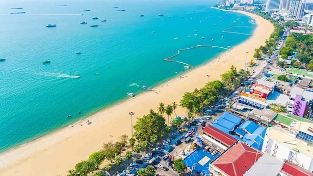 An aerial view of a coastal city with a sandy beach, clear blue waters, and a mix of residential and commercial buildings. - Japanese Styled Condo in the Heart of Pattaya next to Pattaya Beach. (Pattaya City)