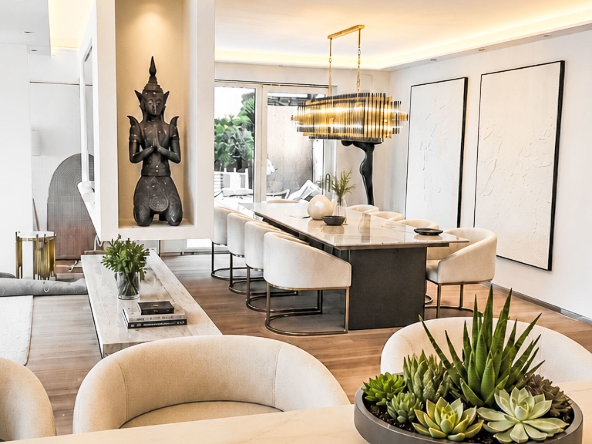 A modern living room with a sofa, a coffee table, and a dining area with chairs and a table.