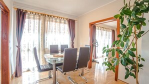 A conference room with a glass table, four chairs, and a potted plant. - Apartment Renato by Interhome (Rovinj/Kanfanar)