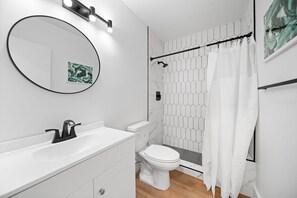 A modern bathroom with a white sink, toilet, and shower. - 261 #11 Managed by Brampton Park (Deerfield Beach)