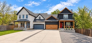 A two-story house with a garage, a covered porch, and a driveway. - 2 Homes, 8BR | Sleeps 30 | Game Room & Fire Pit (Denver)