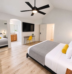 A modern bedroom with a bed, a desk, and a chair. - 2 Homes, 8BR | Sleeps 30 | Game Room & Fire Pit (Denver)