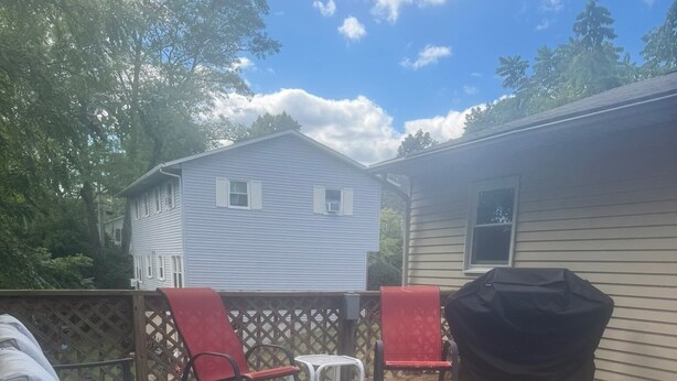 A patio area with a sofa, two chairs, a table, and a barbecue grill. - Your Penn State Destination pt 3 (State College)