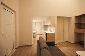 A modern apartment with a living room, kitchenette, and a dining area. - Duplex City 06 07 in Durr s (Durrës)
