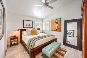 A bedroom with a bed, bedside tables, a bench, a ceiling fan, and artwork on the walls. - Vegas Designer Private Pool Oasis, King Suite, BBQ (Las Vegas)