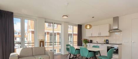 A modern apartment with a living area, dining space, and kitchen.