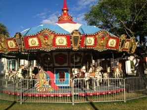 A carousel with ornate decorations and a central figure.