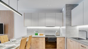 Eine moderne Küche mit Holzausstattung, einem Einbauofen und einer Arbeitsplatte mit einem Toaster.