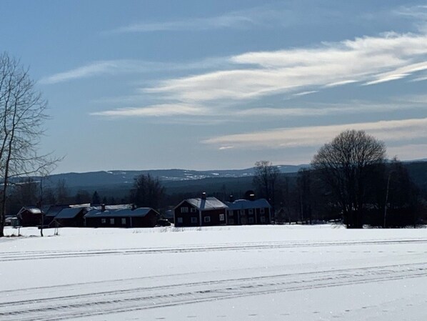 A snow-covered landscape with houses and a clear sky.